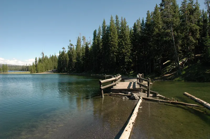 Photo: DimiTalen / CC0, via Wikimedia Commons Broken wooden footbridge on the Yellowstone Lake shore, Grant Village Campground, Yellowstone National Park