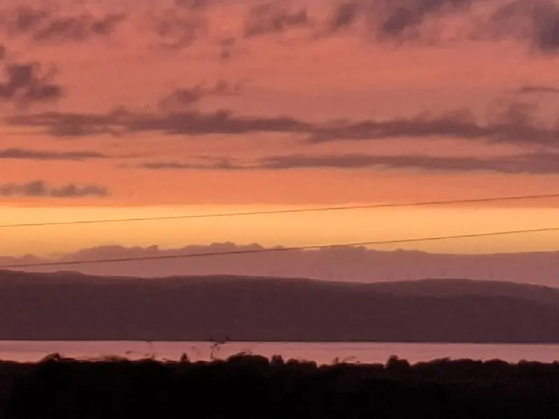 Photo: Caroline Martin / CC BY-SA 2.0, via Wikimedia Commons September sunset from Bridgend Campsite