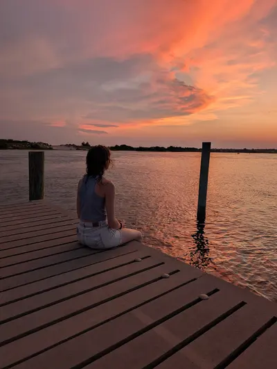 Woman on dock at sunset in Cedar Point NC, near Swansboro